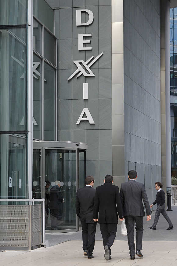 Businessmen walk outside the Dexia tower in La Defense, near Paris.