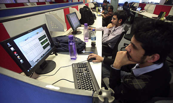 Employees of Snapdeal.com, an Indian online discount shopping website, work inside their company office in New Delhi.