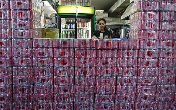 Crates of Coca-Cola are stacked outside a counter of a coffee shop in Singapore.
