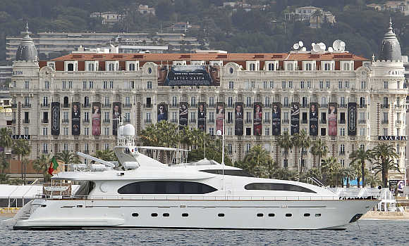 A yacht cruises past the Carlton Hotel in Cannes, France.