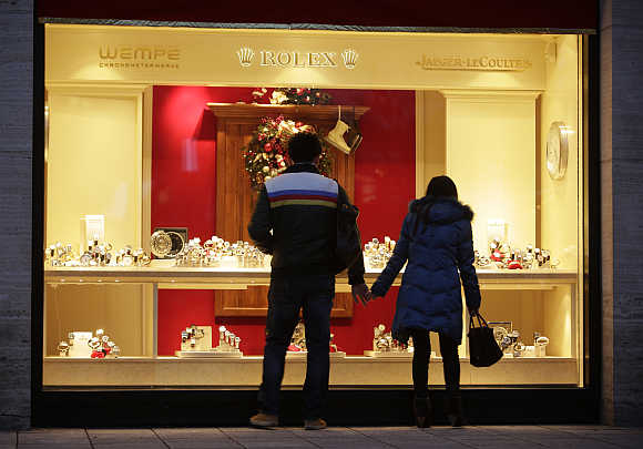 A couple looks into a shop window of a jeweller in Frankfurt, Germany.