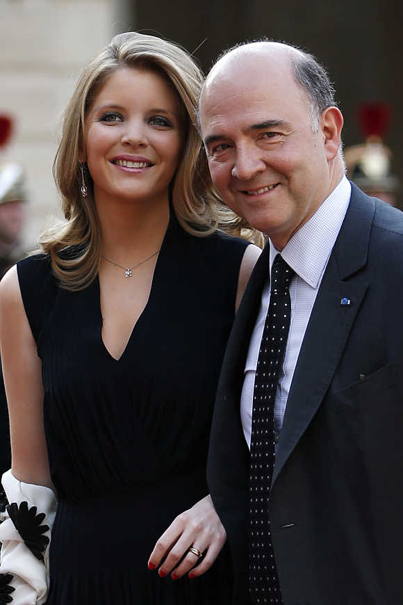 French Finance Minister Pierre Moscovici and his companion Marie-Charline Pacquot arrive for a state dinner hosted at the Elysee Palace in Paris.