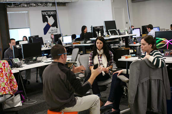 Employees gather in their work environment for a discussion at the headquarters of Facebook in Menlo Park, California.