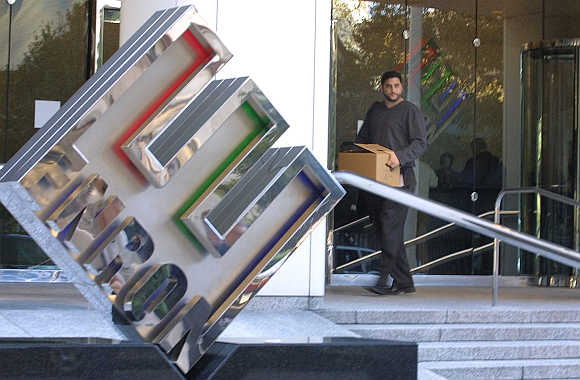 An employee walks out the front door of the Enron building in downtown Houston. A file photo.