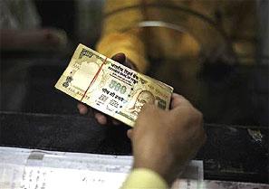 A man deposits his money in a bank. Photograph: /Yasir Iqbal/Reuters