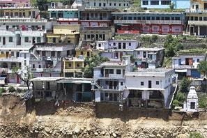  Damaged houses are seen at a village in Rudrapraya. Photograph: Danish Siddiqui/Reuters g