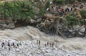 Soldiers try to repair a temporary footbridge over River Alaknanda after it was destroyed, during rescue operations in Govindghat in Uttarakhand June 22, 2013. Photograph: Danish Siddiqui/Reuters