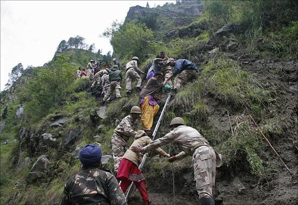Soldiers rescue stranded people after heavy rains in Uttarakhand.