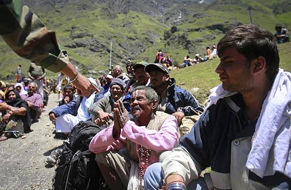  A survivor pleads with a soldier to allow him to board an army helicopter, during rescue operations at Badrinath.