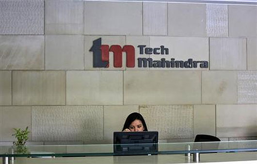An employee sits at the front desk inside Tech Mahindra office building in Noida.