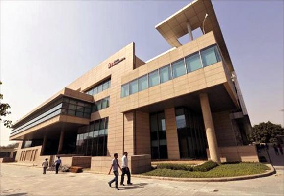 Employees walk inside Tech Mahindra office premises in Noida.