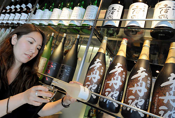Japanese sommelier Sayaka pours a glass of sake wine at the Zuma restaurant in central London.