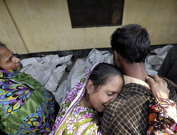 Relatives mourn the death of a garment worker after a fire occurred in a garment factory in Savar.