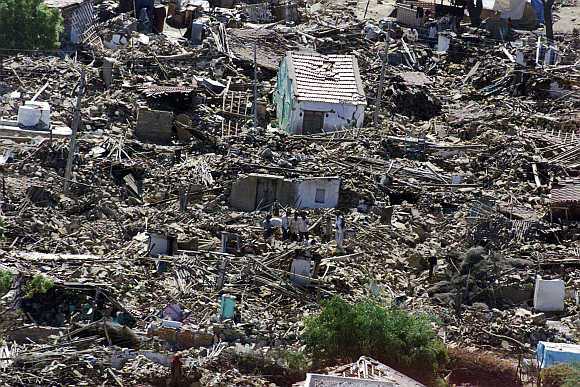 An aerial picture shows villagers amid their destroyed homes in Jikadi in Gujarat on February 2, 2001.