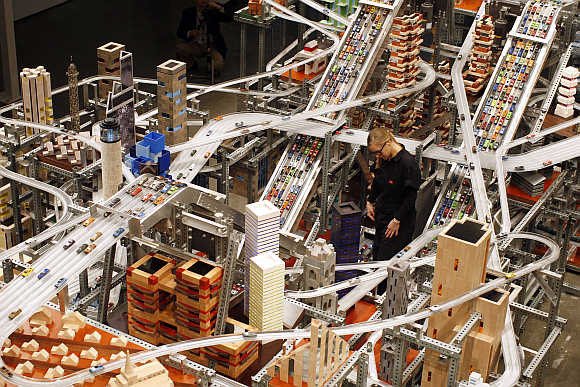 Alison Walker watches miniature cars move along the elevated freeway at Chris Burden's large-scale kinetic sculpture, Metropolis II, at the Los Angeles County Museum of Art, California.