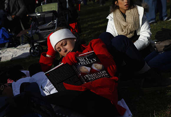 A woman reads a book at the National Mall in Washington, DC.