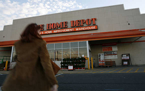 A woman walks towards a Home Depot store in Alexandria, Virginia, United States.