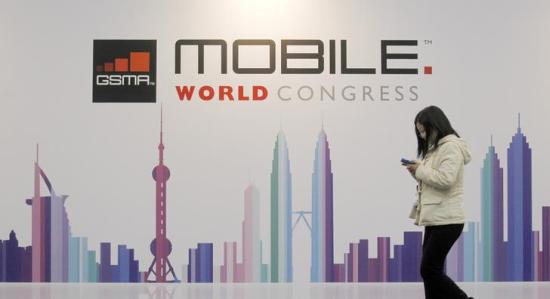 A visitor walks past a Mobile World Congress banner in Barcelona.