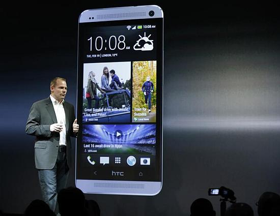 HTC president Jason Mackenzie shows the new HTC One.