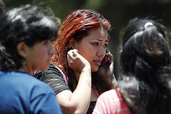 A woman reacts as she talks on her mobile phone in the business district of Santa Fe, Mexico City.