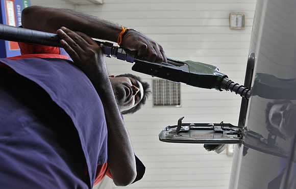 A worker fills diesel at a fuel station in Chennai.