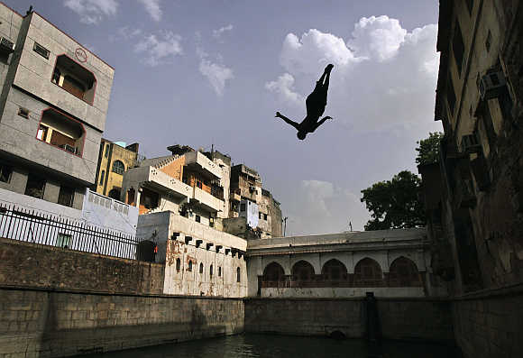 A boy jumps into a well inside the shrine of Sufi Saint Nizamuddin Auliya in New Delhi. Above, Nandan Nilekani.