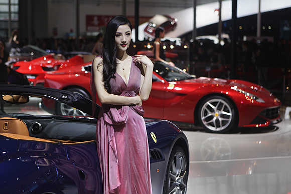 A model stands next to a Ferrari California in Beijing, China.