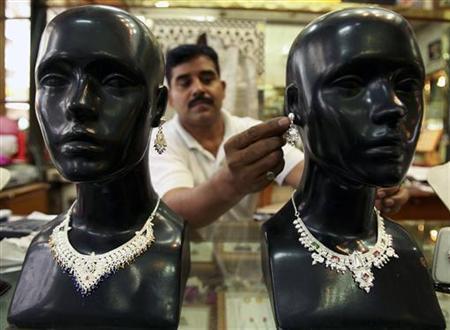 A shopkeeper displays silver jewellery at a shop in Jammu.