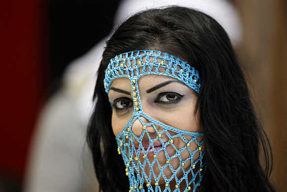 A girl in a transparent face veil attends the international tourism industry fair in Berlin.