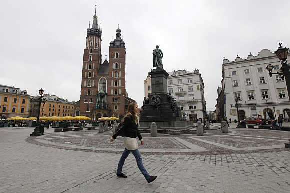 A woman walks in front of St Mary's Basilica in Krakow, Poland.