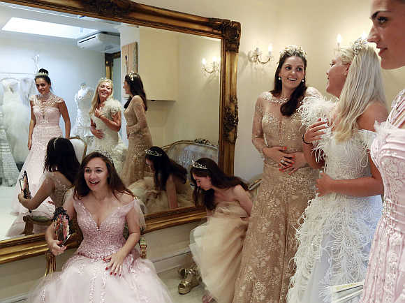 Debutantes Maria Austin, Amelia Simmons, Sophie Bonello, Zoe Rawson, and Georgina Riddle attend a dress-fitting for Queen Charlotte's Ball in central London, United Kingdom.