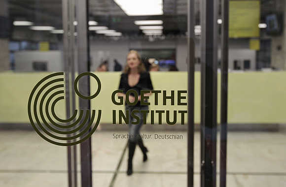 A woman walks inside the Goethe-Institut in Athens, Greece.