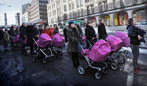 People march through downtown Stockholm as part of a campaign to stop maternal mortality on International Women's Day, Sweden.