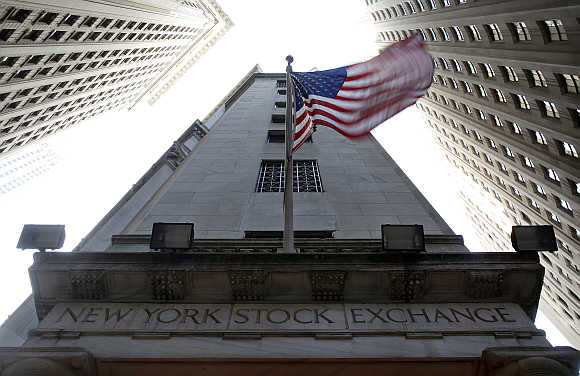 The US flag waves above one of the entrances to the New York Stock Exchange.