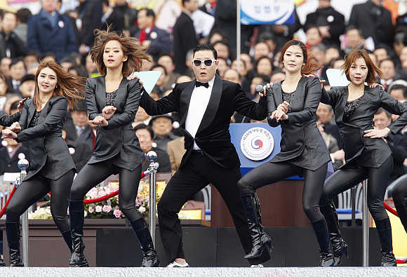 Singer Psy centre, performs at the parliament in Seoul.