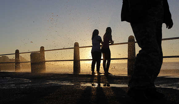 People cool off as waves hit the sea point promenade in Cape Town.