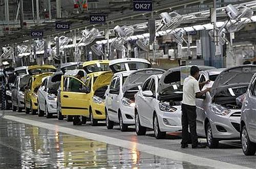 Workers assemble cars inside the Hyundai Motor India's plant.