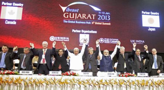Country's top businesspersons, diplomats and Gujarat chief minister Narendra Modi hold their hands up together during the Vibrant Gujarat Summit.