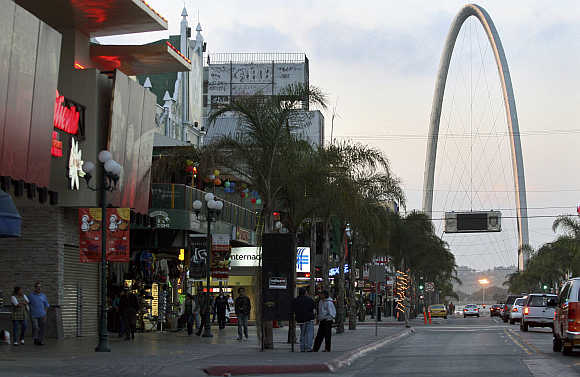 People walk at the Revolucion avenue in the border city of Tijuana, Mexico.