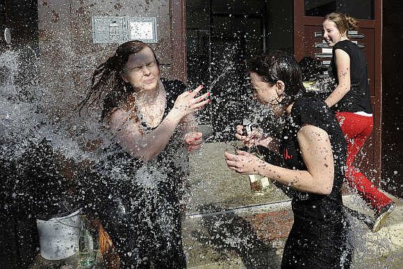Girls are hit by water from a bucket thrown by Slovak youths as part of Easter celebrations in Trencianska Tepla, 145km north of Bratislava, Slovakia.