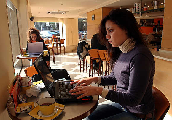 Women work on their computers at a cafe in Cairo, Egypt.