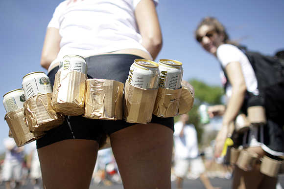 A girl carries a belt of beers during the Race of Beer in Brasilia, Brazil.