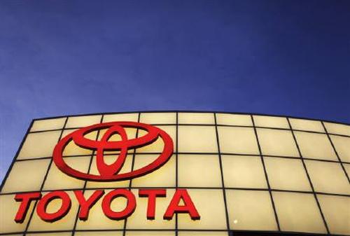 The Toyota logo is lit up above its dealership.