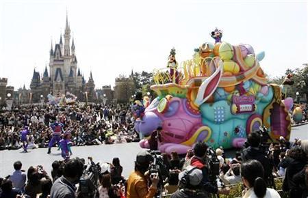 Disney character Mickey Mouse (top) performs atop a float during a parade at Tokyo Disneyland in Urayasu.