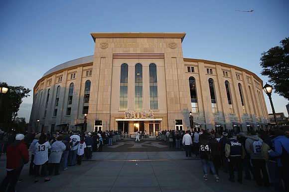 Fans line up to enter Yankee Stadium in New York.