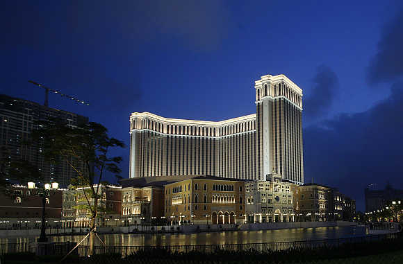 Venetian Macao casino resort of Las Vegas Sands is seen lit up in the evening in Macau.