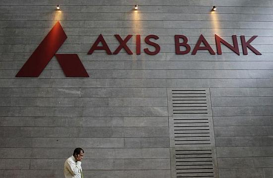 An employee speaks on his mobile phone as he walks inside Axis Bank's corporate headquarters in Mumbai.