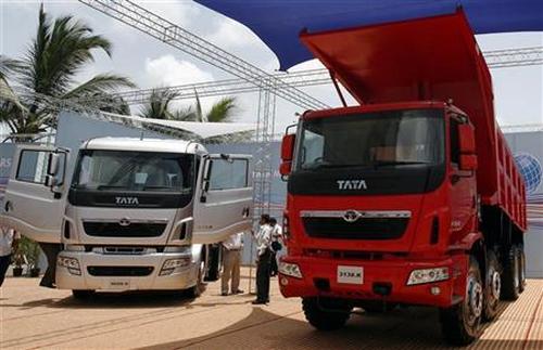 Tata Motors' trucks are displayed during a news conference.