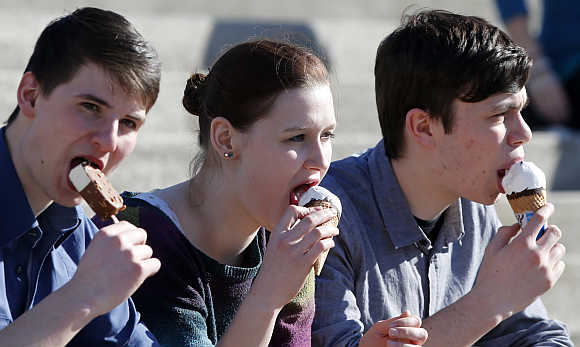 Visitors eat ice cream at the CeBit computer fair in Hanover, Germany.