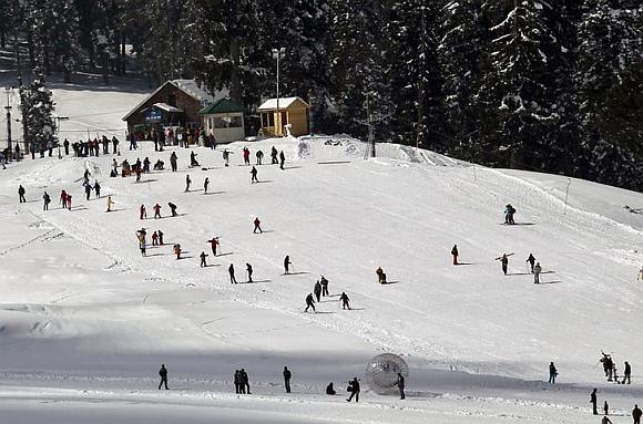 Tourists and skiers ski on a slope in Gulmarg, 55 km (34 miles) west of Srinagar.